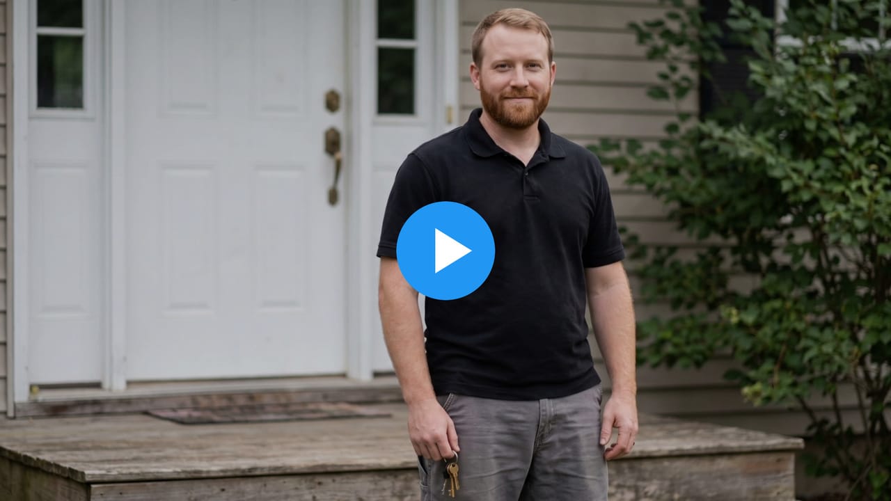 Pete, a locksmith, on a front porch beside a front door